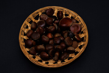 Wooden basket filled with chestnuts