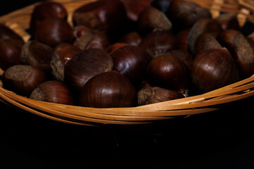 Wooden basket filled with chestnuts