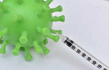 figure of a virus and a syringe with vaccination