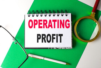 OPERATING PROFIT text on notebook on green paper