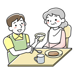 座って食事をするシニア女性と介助する男性職員