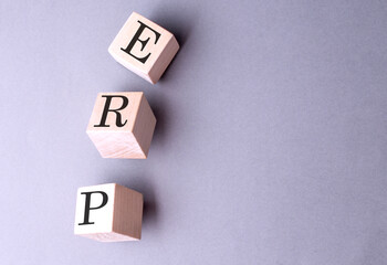 Obraz premium Word ERP - Enterprise Resource Planning on wooden block on the grey background