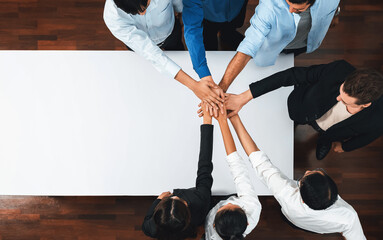 Panorama banner top view group of diverse office worker join hand over meeting table. Business...