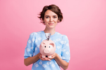 Fototapeta na wymiar Photo of lovely positive person hands hold money bank pig dollar bills isolated on pink color background
