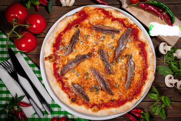neapolitan pizza with tomatoes anchovies capers close up wooden table
