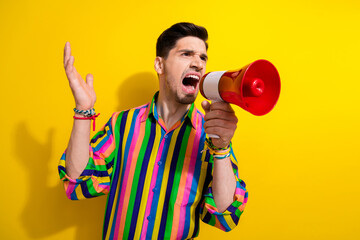 Photo of young aggressive businessman holding bullhorn angry screaming during conflict with...