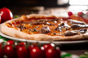 neapolitan pizza with tomatoes anchovies capers close up wooden table