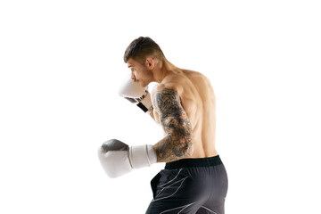 Muscular strong athletic young guy, athlete training, boxing isolated over white background. Strong...