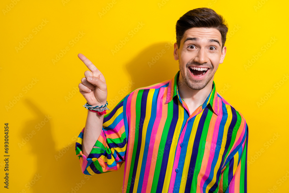 Sticker Photo of young boyfriend glamour striped shirt point finger novelty empty space opening dancehall isolated on yellow color background