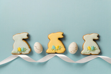 Easter homemade baked gingerbread or cookies with pattern of icing, bunny and eggs. White...
