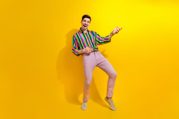 Fototapeta na wymiar Full body photo of crazy man hold invisible guitar playing musical instrument at vintage style party isolated on yellow color background