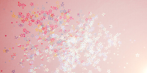 Greeting background with empty space. Pink-blue sparkle sequins, glitter in star shape on a gentle pink background. Top view. Web banner