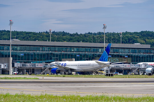 Parked long distance airplanes at terminal Dock Midfield at Zürich Kloten Airport on a sunny summer day. Photo taken July 23rd, 2023, Zurich, Switzerland.