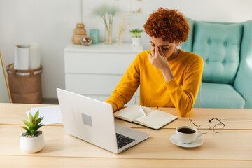 Overwhelmed young african woman suffering from dry eyes syndrome eyestrain pain massaging nose...