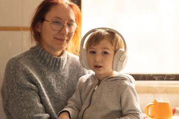 Mother and Child Enjoying Music Together in the Kitchen
