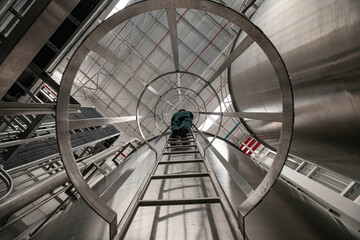 Obraz premium The male worker down the ladder is for inspection stainless steel tank chemical.