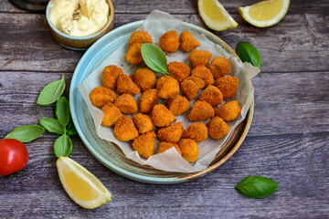 Crispy  deep fried   chicken  nuggets . Breaded  with Cornflakes Breast fillets  with chilly peppers and fresh   basil on wooden rustic background