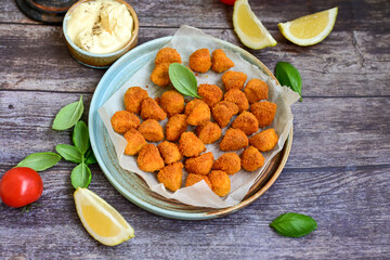 Naklejka na ściany i meble Crispy deep fried chicken nuggets . Breaded with Cornflakes Breast fillets with chilly peppers and fresh basil on wooden rustic background