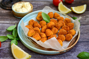 Crispy  deep fried   chicken  nuggets . Breaded  with Cornflakes Breast fillets  with chilly peppers and fresh   basil on wooden rustic background