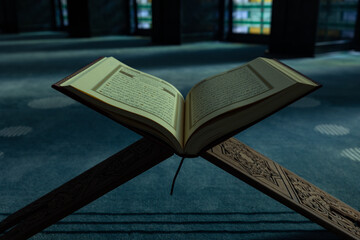Islamic or ramadan kareem or eid mubarak concept. The Holy Quran in a mosque