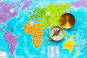 World map and compass for vacation trip concept. Planning travel