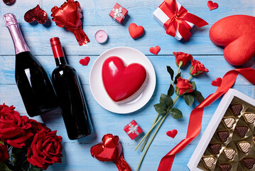 valentines day sweets, cakes and flowers on blue background - obrazy, fototapety, plakaty