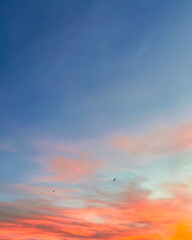 Sunset sky with colorful clouds vertical background concept. Evening sunset. Dusk sky view. Dramatic red, orange and yellow twilight sky. - obrazy, fototapety, plakaty