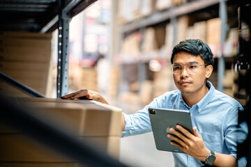 Businessman or supervisor uses a digital tablet to check the stock inventory in furniture large...