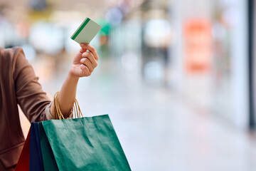Close up of woman shopping with credit card at mall.