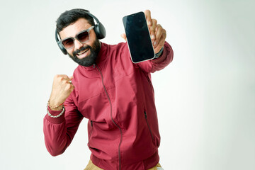 stylish men in jackets, sporting sunglasses, multitasking with headphones and a phone in hand,