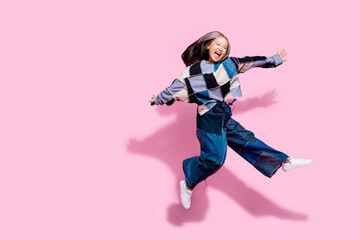 Full size photo of ecstatic active girl dressed jeans pullover oversize pants jumping fooling...