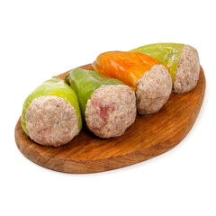 Peppers stuffed with minced meat on a wooden board on a white background, isolated
