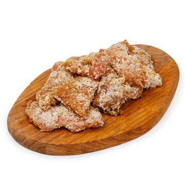 Chicken nuggets raw on a wooden board on a white background, isolated