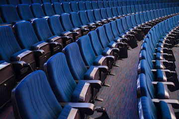 Fototapeta premium High angle view of blue folded bleachers in empty auditorium in conference hall