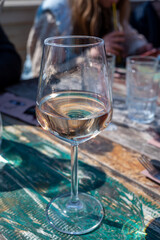 Drinking pinot grigio dry cold wine, served outdoor in beach cafe in North Holland, North sea sandy beach, the Netherlands