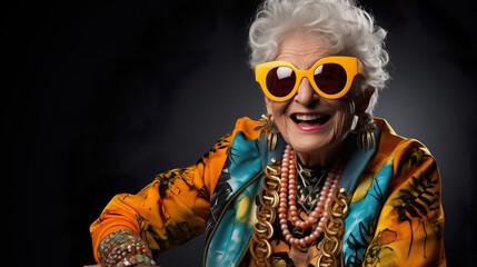 Crazy old granny with gold chain, watch and sunglasses, funny old woman with gray hair, expressive mature and happy smiling grandmother in colorful close-up portrait
