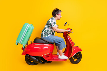 Full length photo of lovely grandma travel bag red moped dressed stylish tropical print garment...
