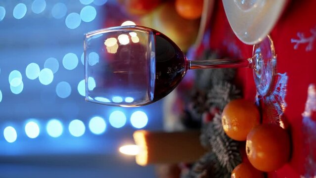 Magic on the table: the Christmas tree is decorated with balls, candles create warmth, and tangerines make the atmosphere special. Holiday gifts are all around. High quality 4k footage