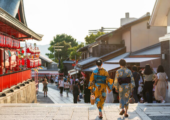 Back view two asian young women wearing Japanese traditional kimono at Fushimi Inari Shrine during...