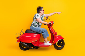 Fototapeta na wymiar Full length photo of lovely grandma ride moped point forward way wear trendy tropical print garment isolated on yellow color background