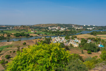 Fototapeta na wymiar Landscape from Puttaparthi with the lake green trees,buildings, temple and ashram from Sai Baba