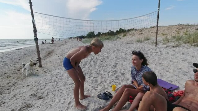 A family resting on the beach after a swim. Kinburn Spit
