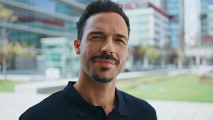 Smiling businessman posing summer street portrait. Relaxed man looking camera