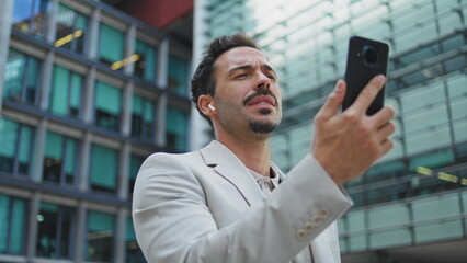 Carefree director talking video call strolling street closeup. Man videocalling