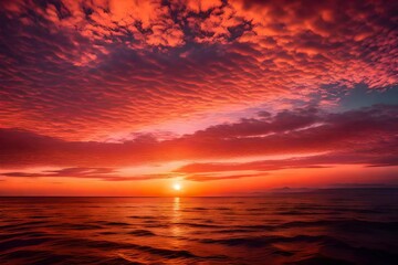 Fototapeta na wymiar The horizon over the ocean glowing with hues of orange and pink as the sun rises, reflecting on the calm waters