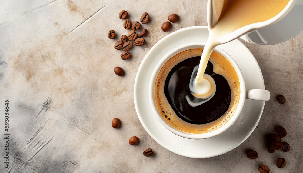 Wall mural pouring milk into cup of coffee, top view