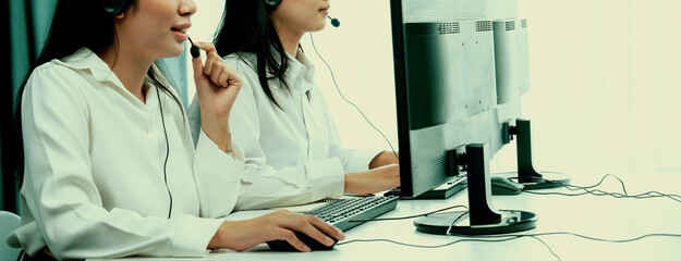 Business people wearing headset working in office to support remote customer or colleague. Call...