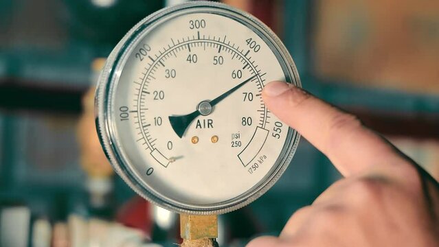 Pressure Gauge Instrument Close-up. Macro shot of a circular pressure gauge showing air unit measurements.
