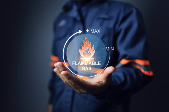 Dangerous goods hazard substance concept with flammable gas and risk level indicator min to max holding by safety staff to encourage and separate management storage area