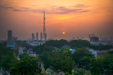 Fototapeta premium Indonesian morning view in the city of Jakarta during a beautiful morning with sunrise and tall buildings